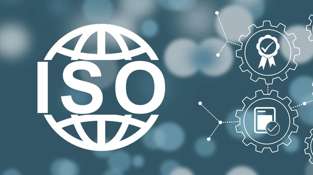 Concept image of ISO certification and quality control, featuring interlocking gears on a dark background.