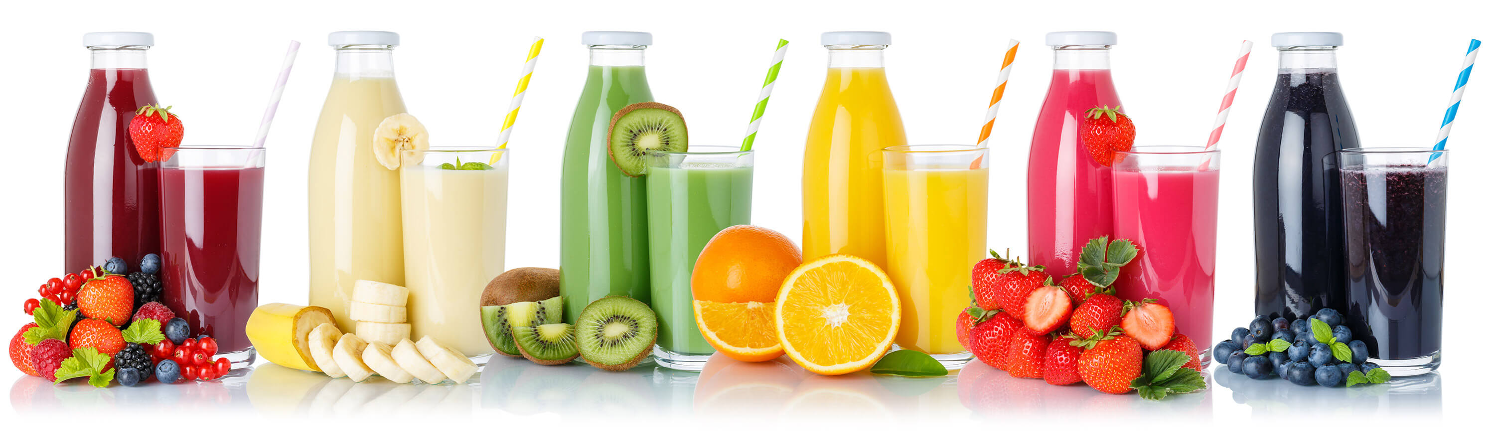 A collection of fruit juice bottles and glasses is arranged on a white background.