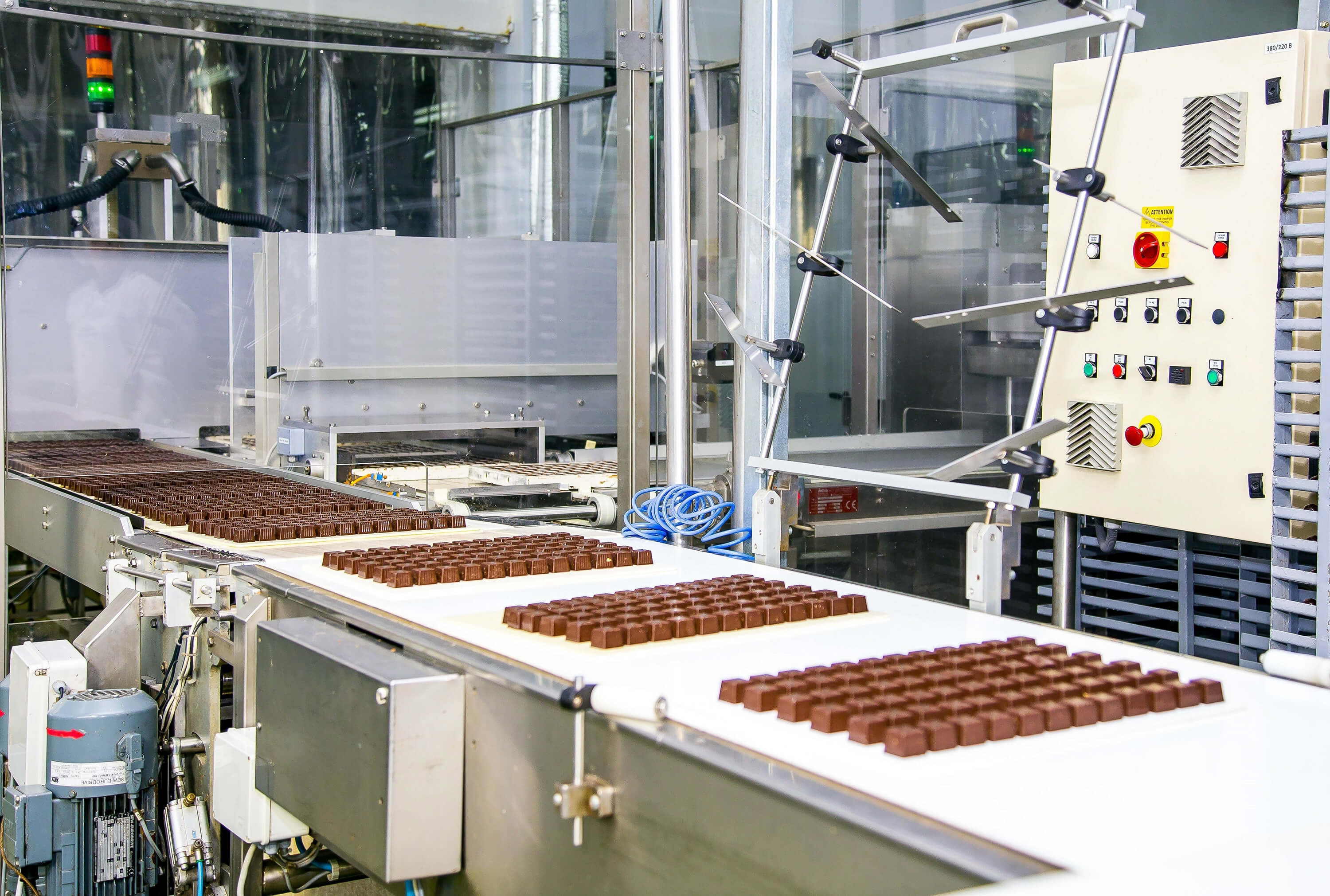 Sweets move along a conveyor belt during the production process in a factory.