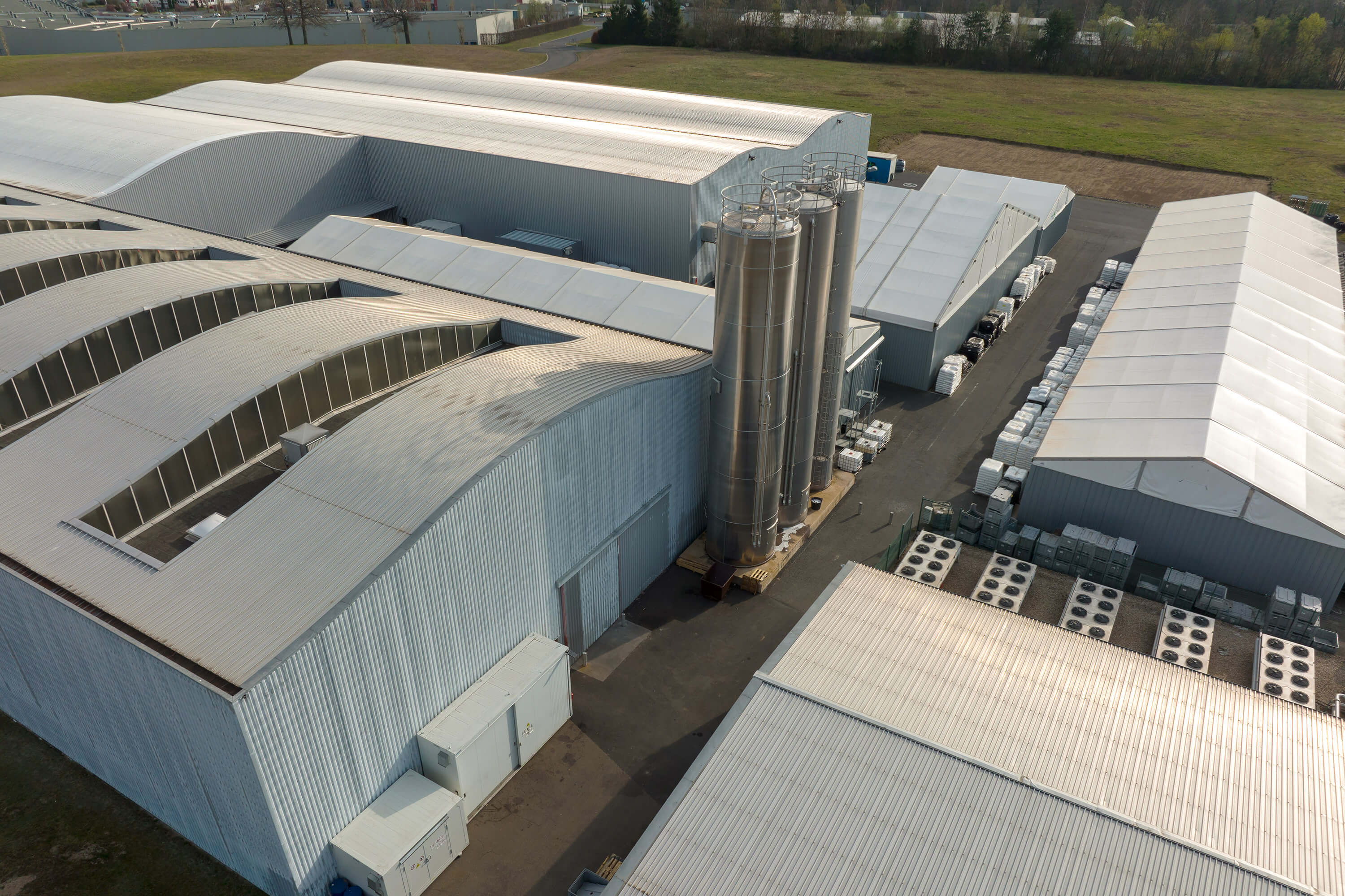 Aerial view of a new factory building used for producing and shipping industrial equipment.