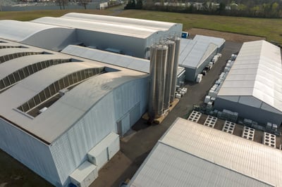 Aerial view of a new factory building used for producing and shipping industrial equipment.