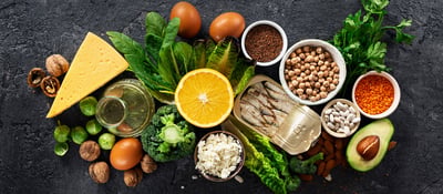 Top view of foods rich in omega-3 and healthy fats on a dark background.