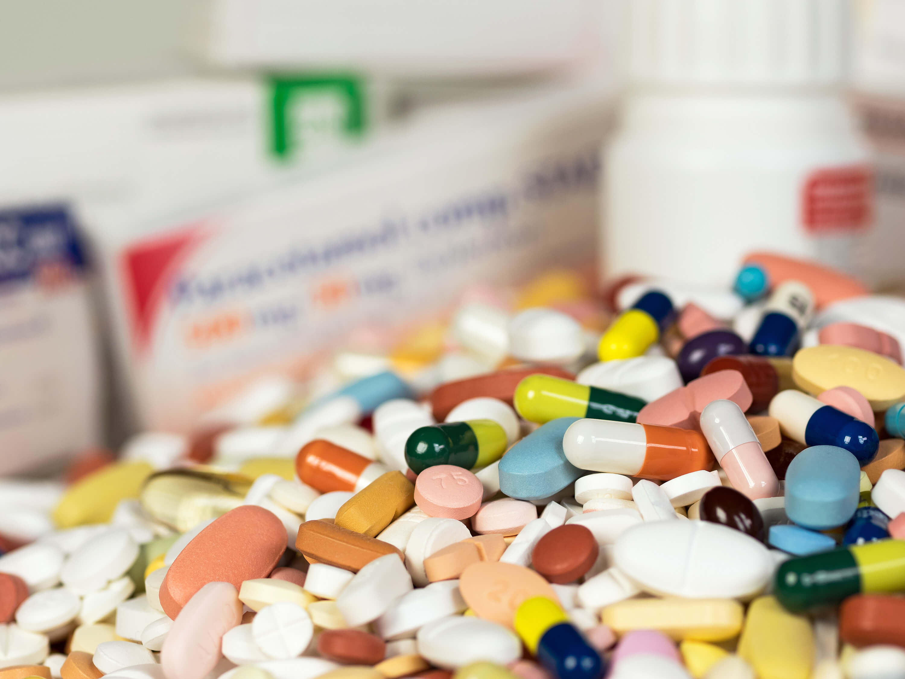 A pile of tablets and pills, illustrating medication use and pharmaceutical treatment.