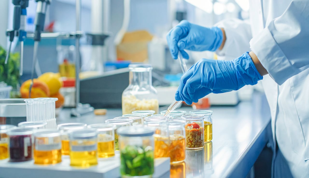 A lab-coated individual is engaged in research activities within a well-equipped laboratory environment.