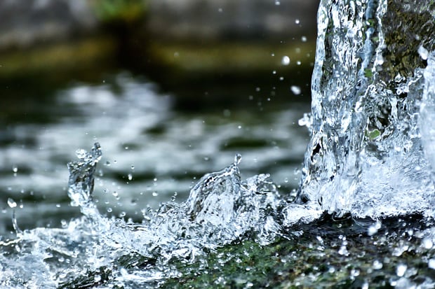 Water splashing into a natural stream or fountain.