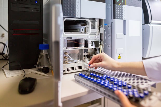 Laboratory scientist preparing samples for high-performance liquid chromatography mass spectrometry.