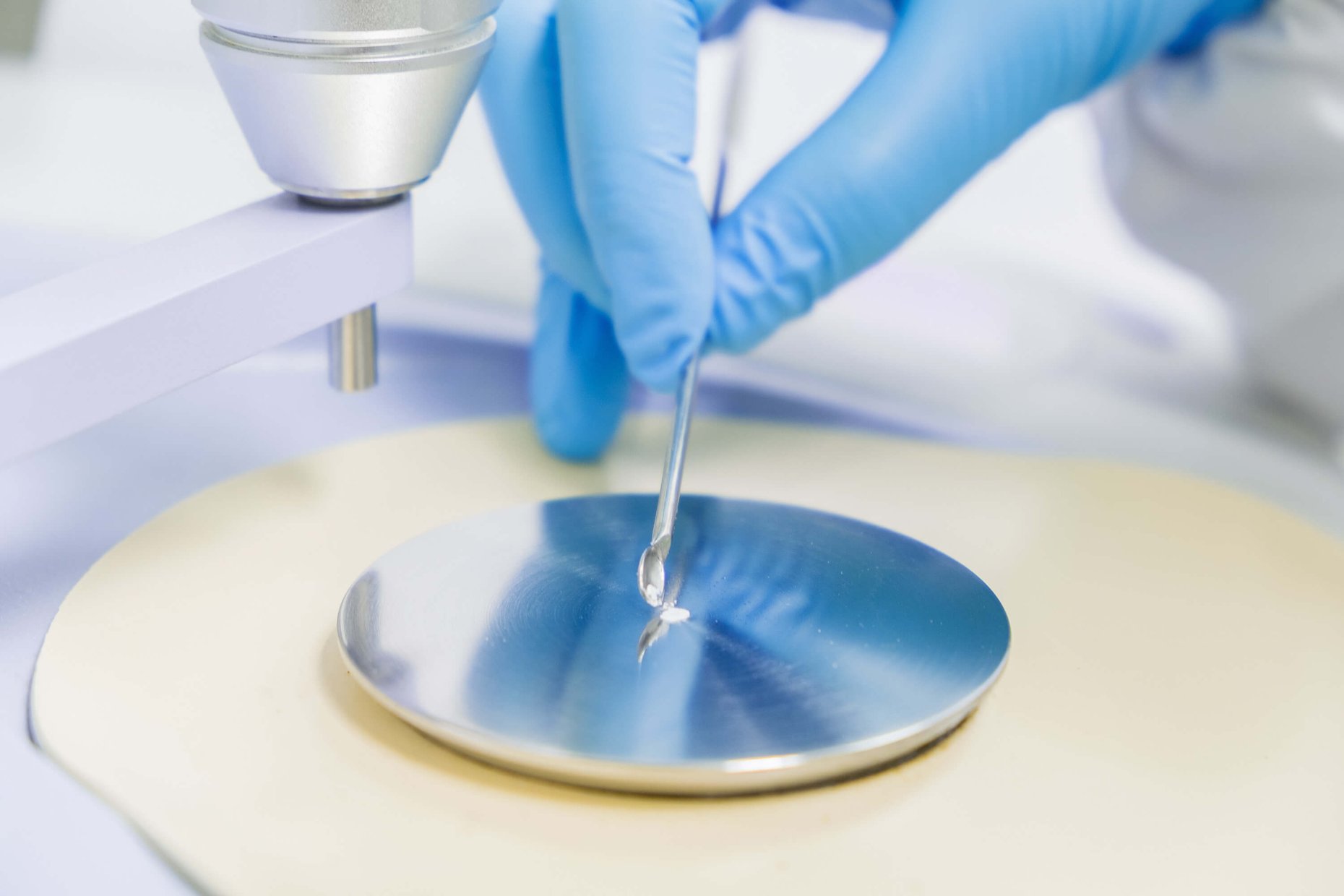 Chemist testing raw material identification with an FTIR spectrometer in a quality control laboratory.