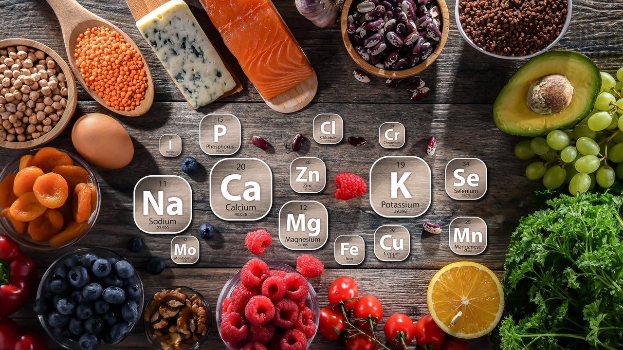 Mineral-rich foods with essential nutrient symbols on a wooden table.