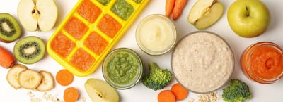 A top view of baby food with fruits and vegetables on a white background.