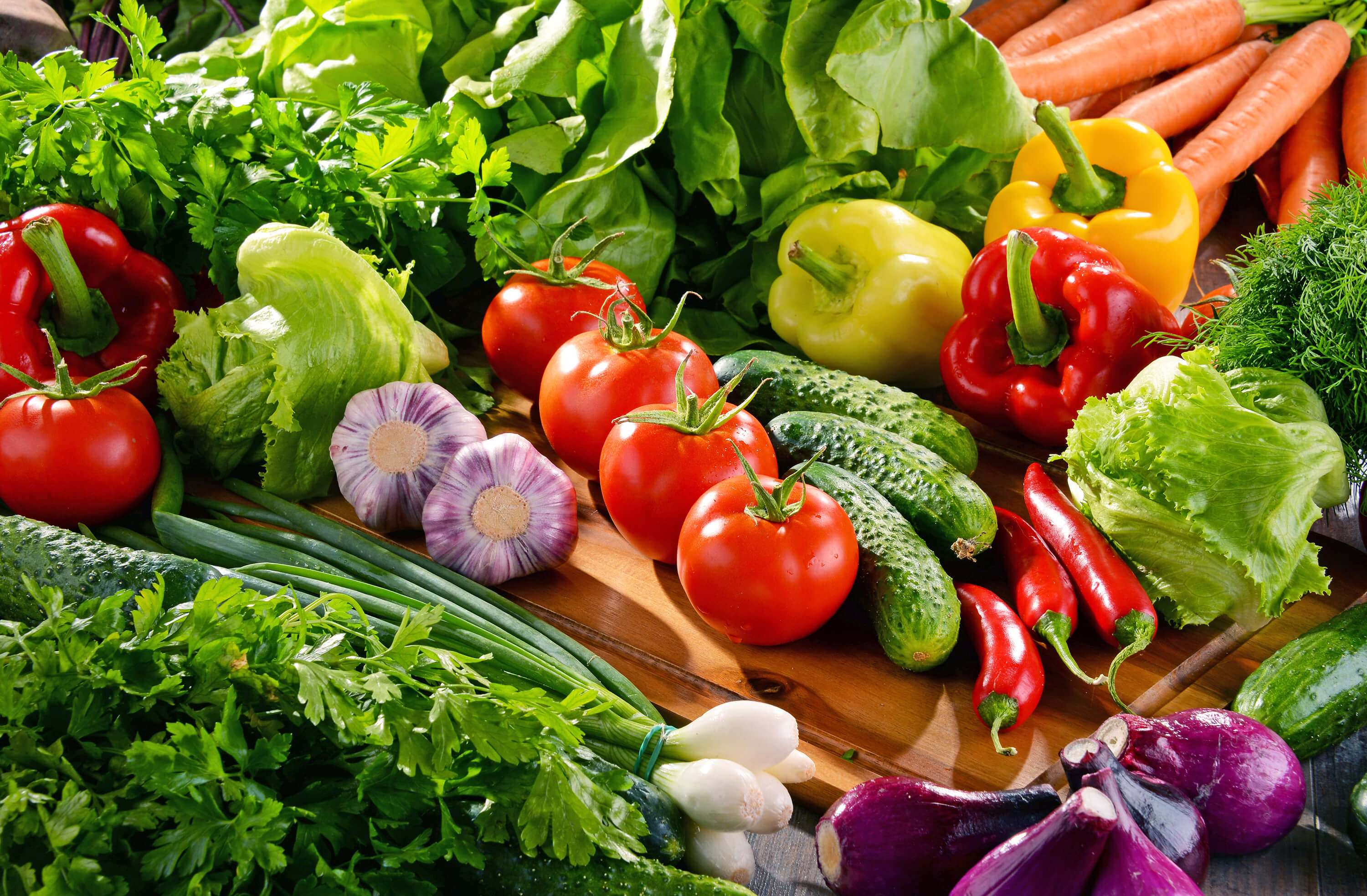 Composition with variety of fresh organic vegetables and fruits.