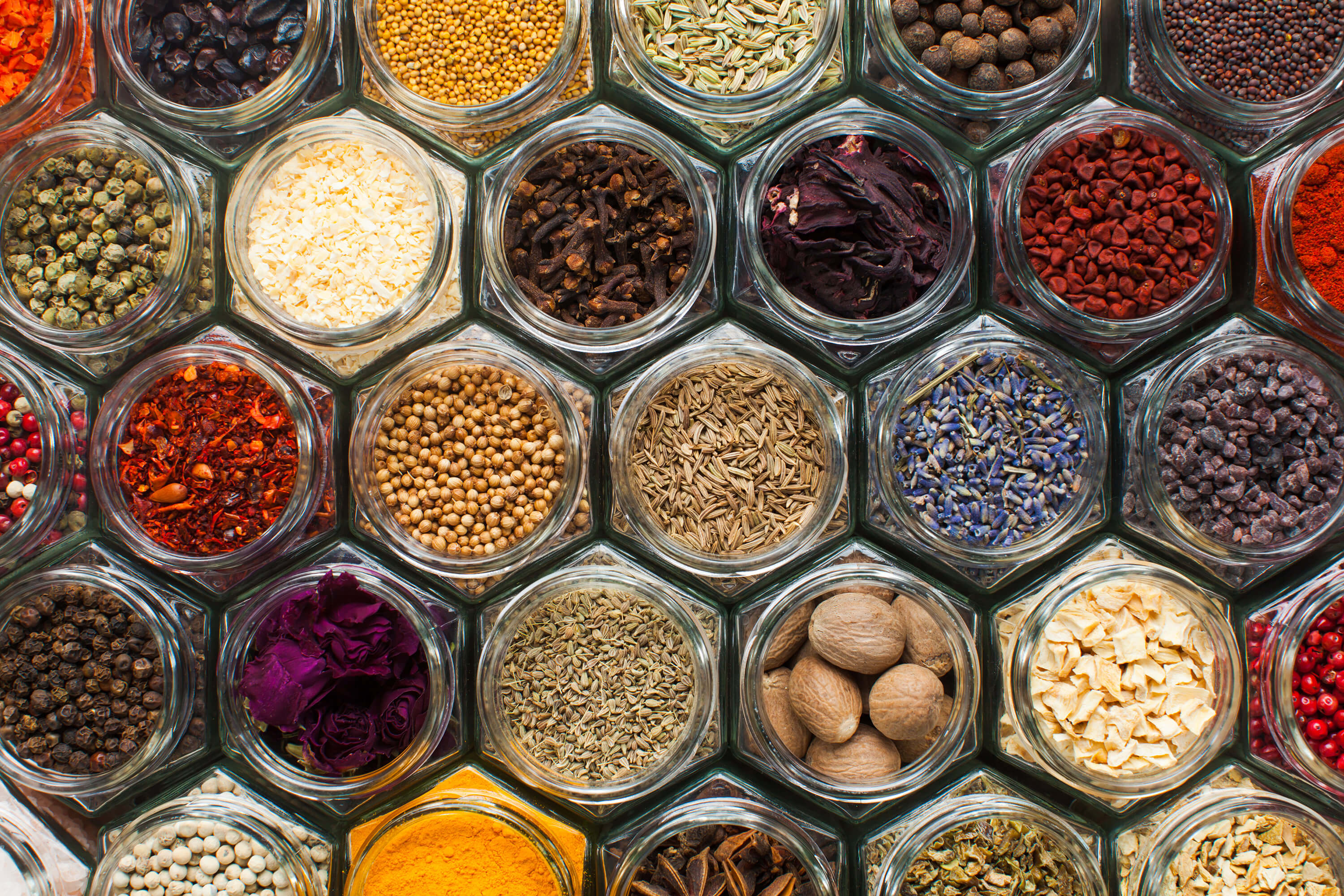 A top view of spice bottles arranged in a patterned composition.