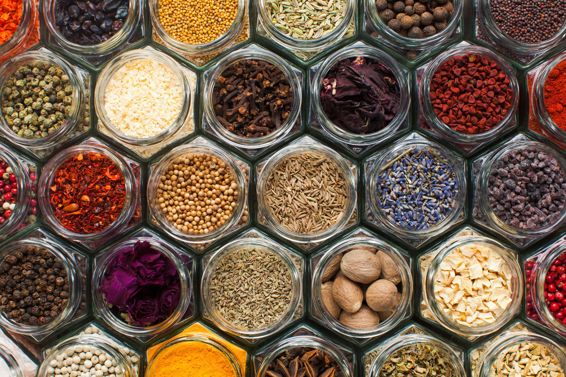A top view of spice bottles arranged in a patterned composition.