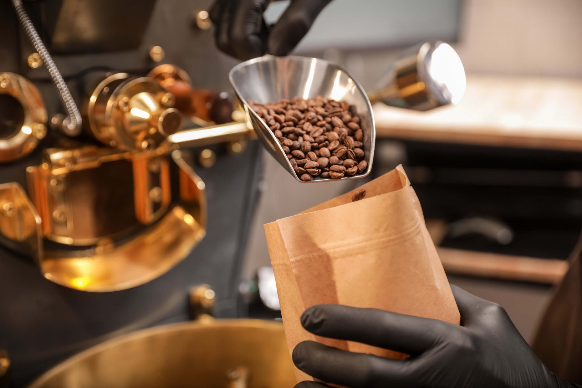 A person packages coffee beans after roasting.