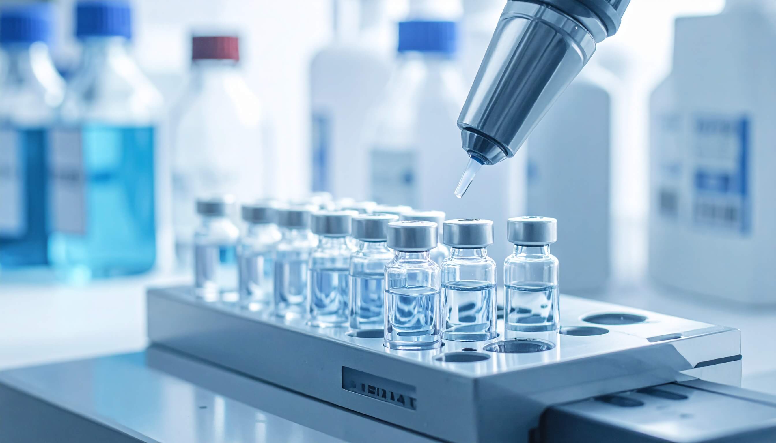 A laboratory scene with various vials and an autosampler machine, indicating a setup for scientific experiments.