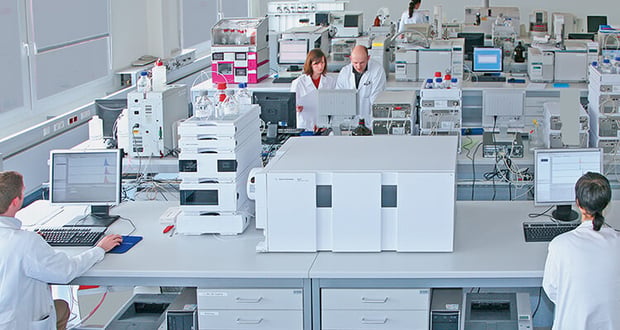 A diverse group of people collaborating in a laboratory setting, engaged in scientific research and experimentation.