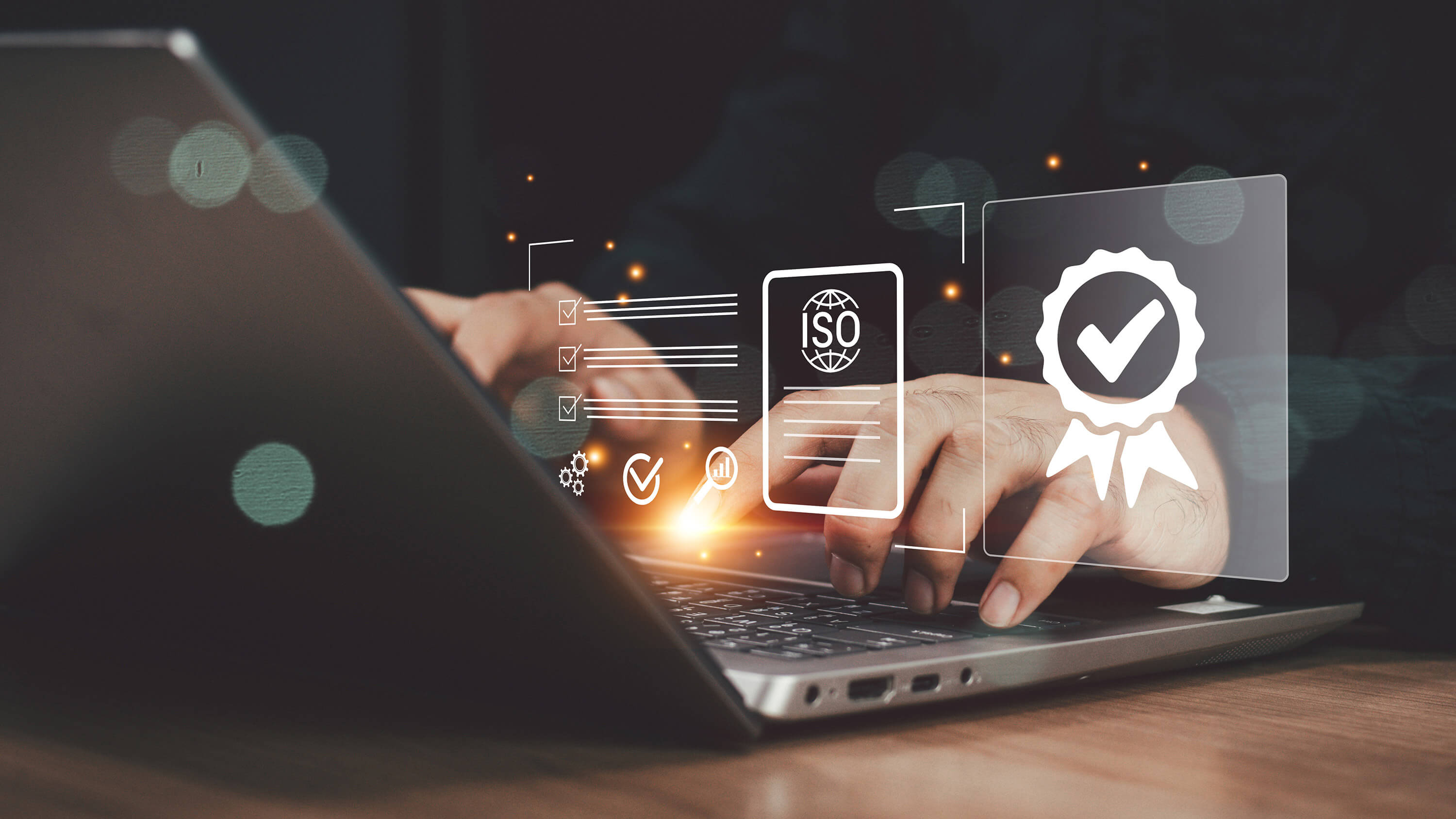 Hands using a laptop with an overlaid illustration of a checklist and certification-style security symbols.