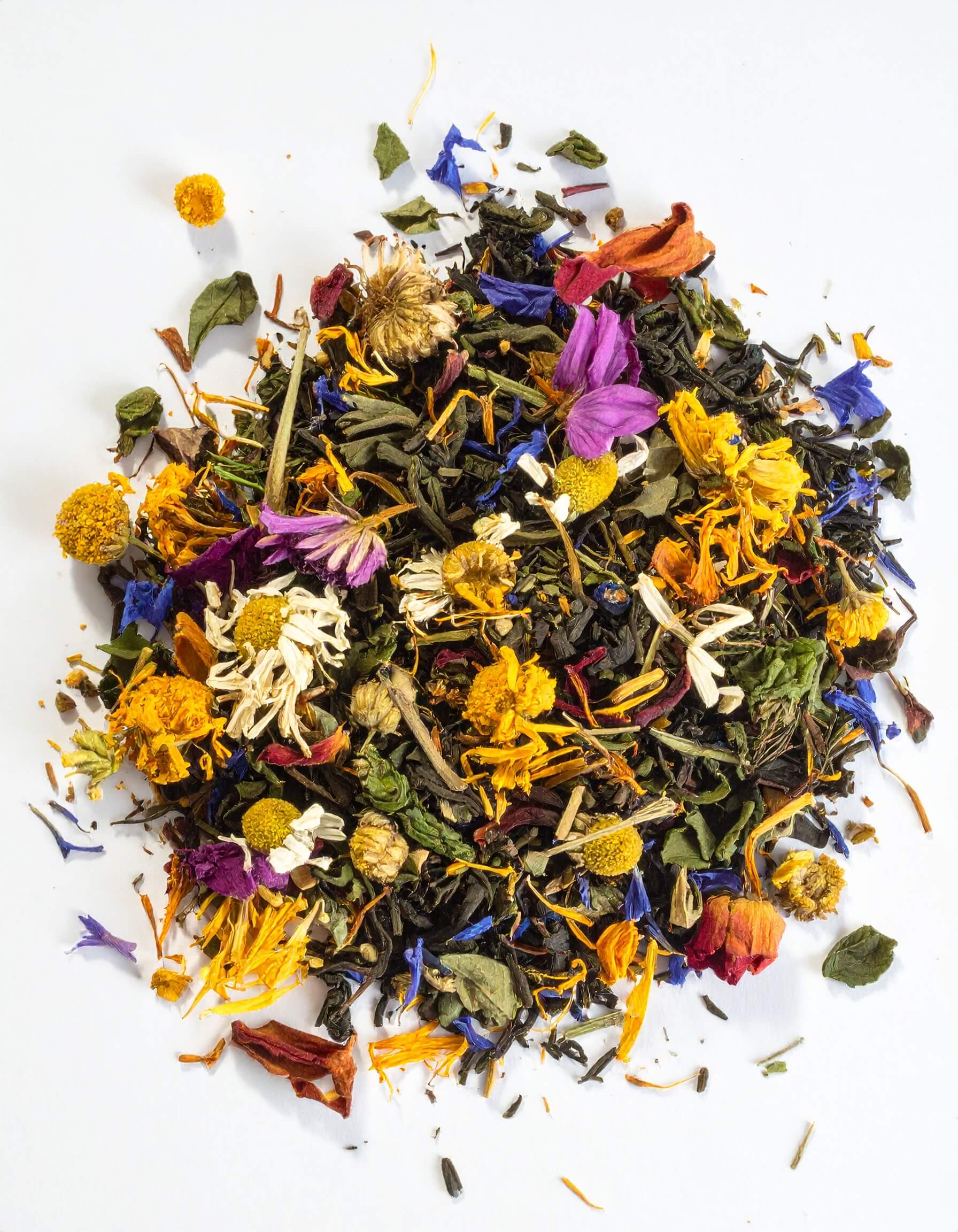 A pile of loose tea featuring a blend of various flowers and herbs, showcasing vibrant colors and textures.