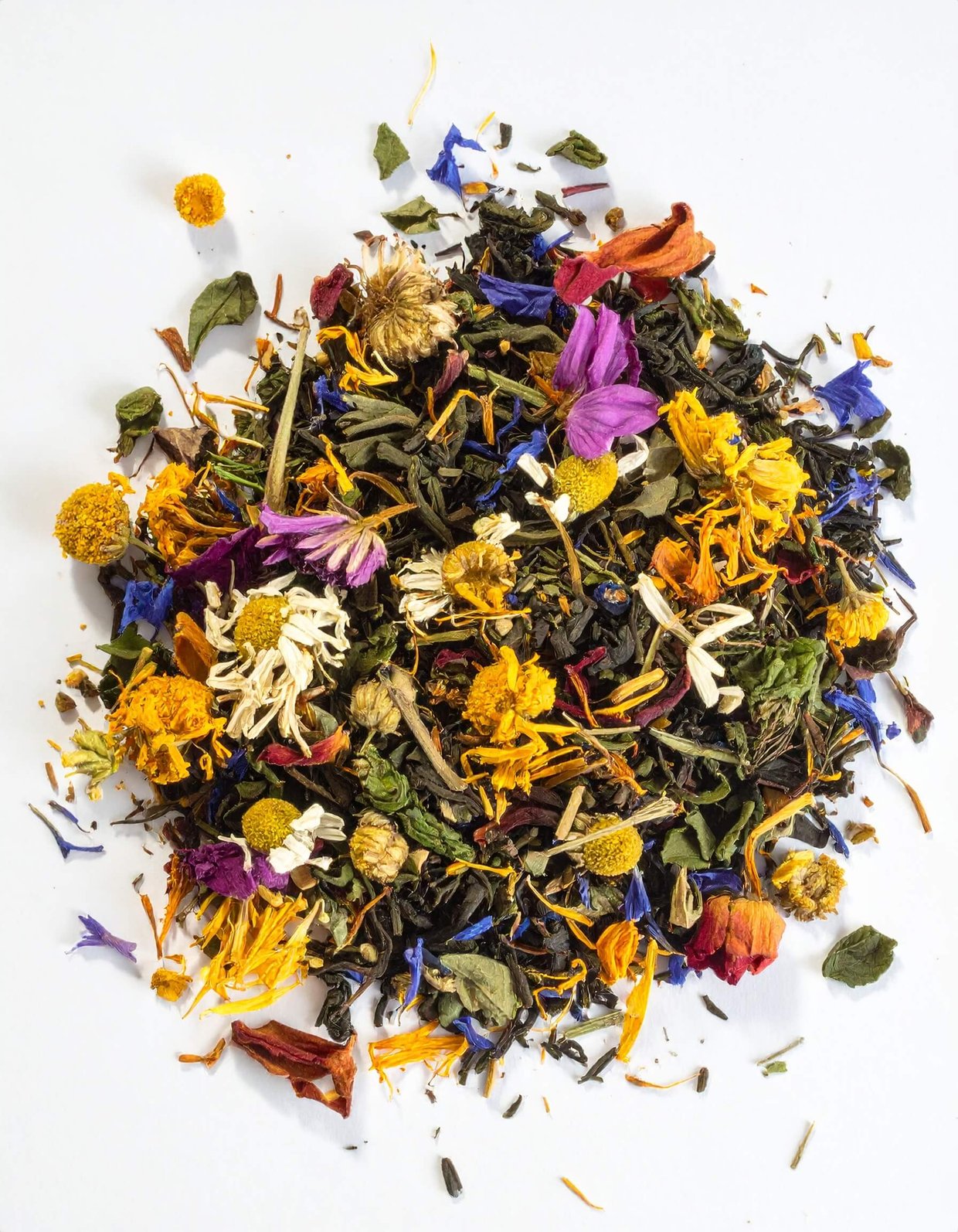 A pile of loose tea featuring a blend of various flowers and herbs, showcasing vibrant colors and textures.