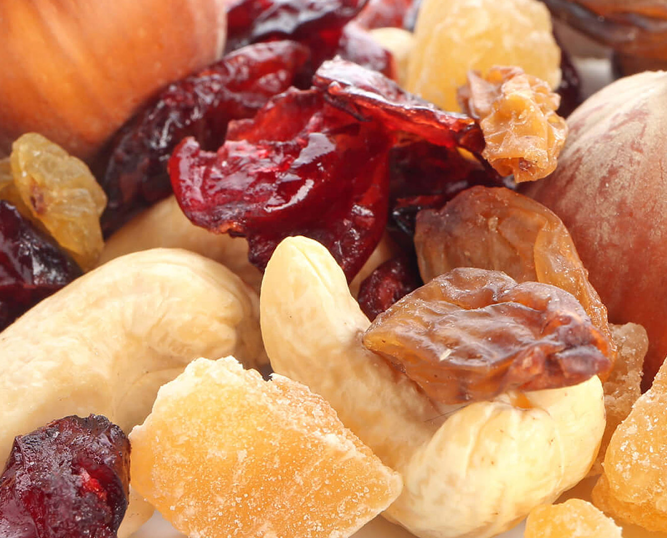 Different dried fruits and nuts on white background