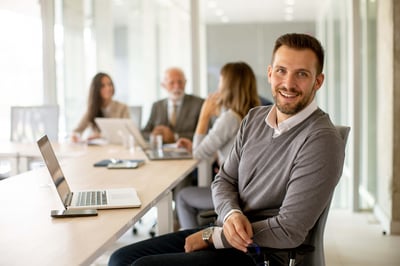Young business man working with his teammates in the office.