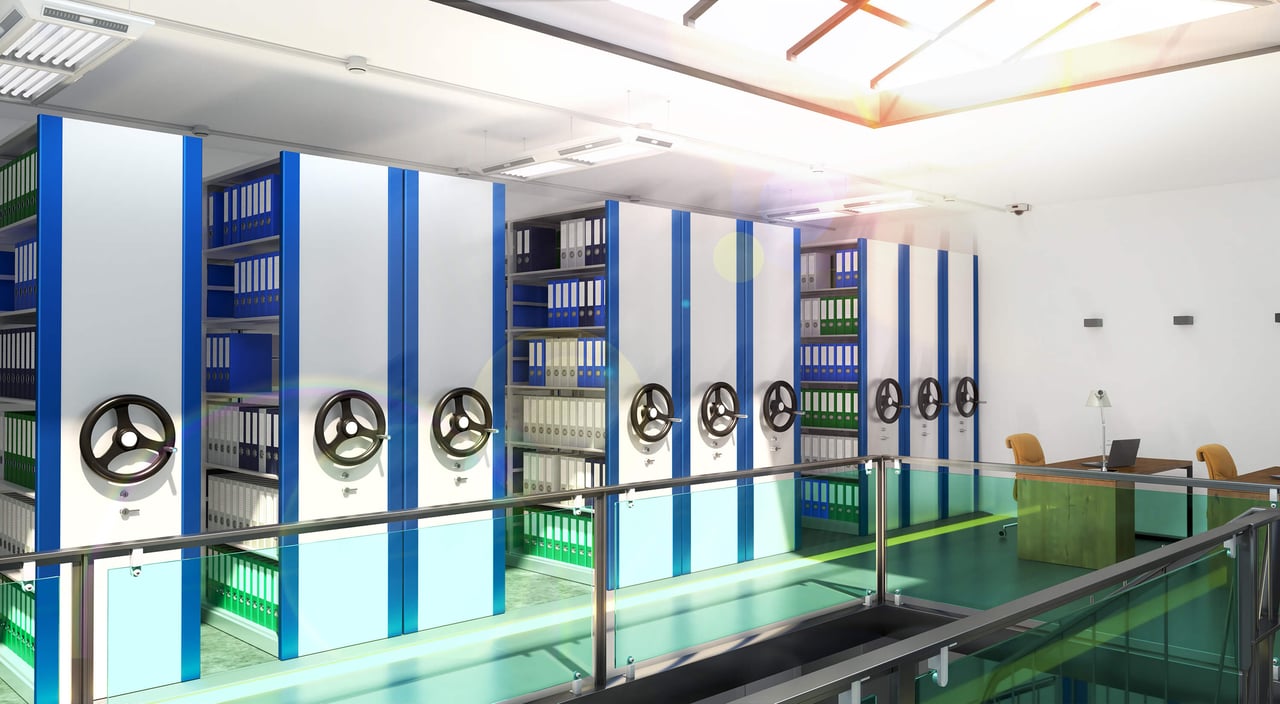 Modern archive room with mobile shelving units filled with document binders.