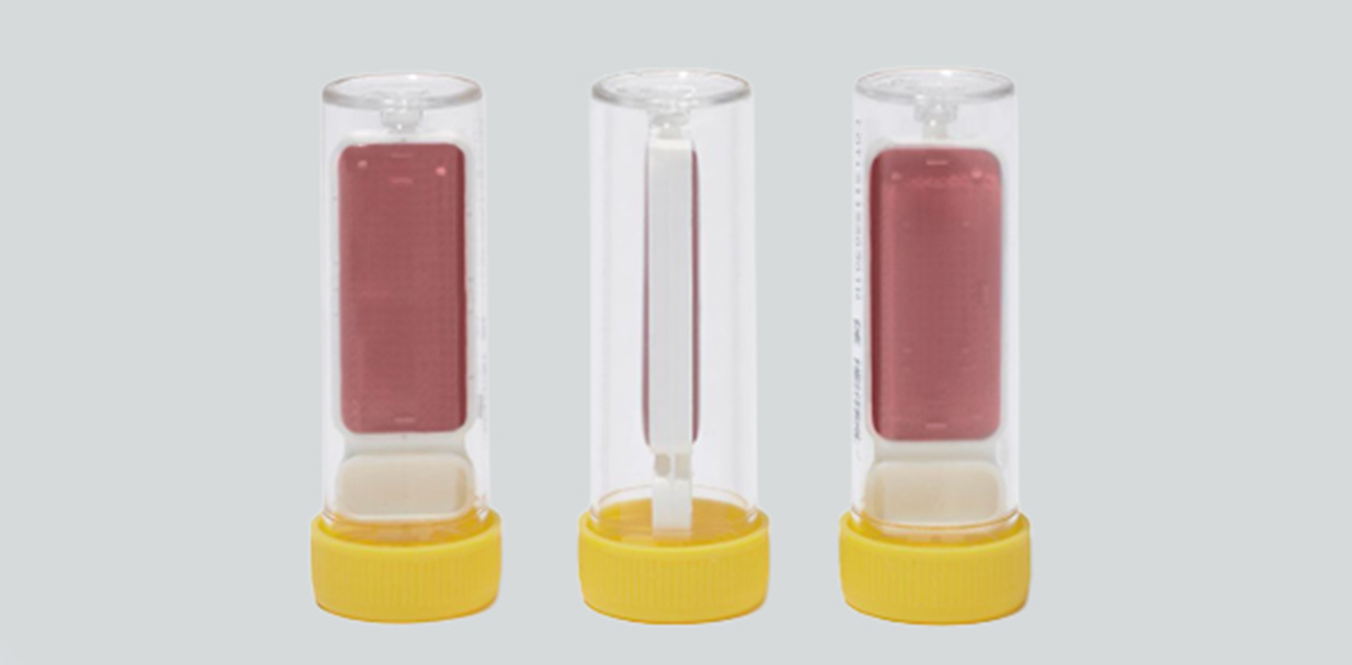 Contact test swabs in transparent tubes with red agar medium for microbiological surface analysis.