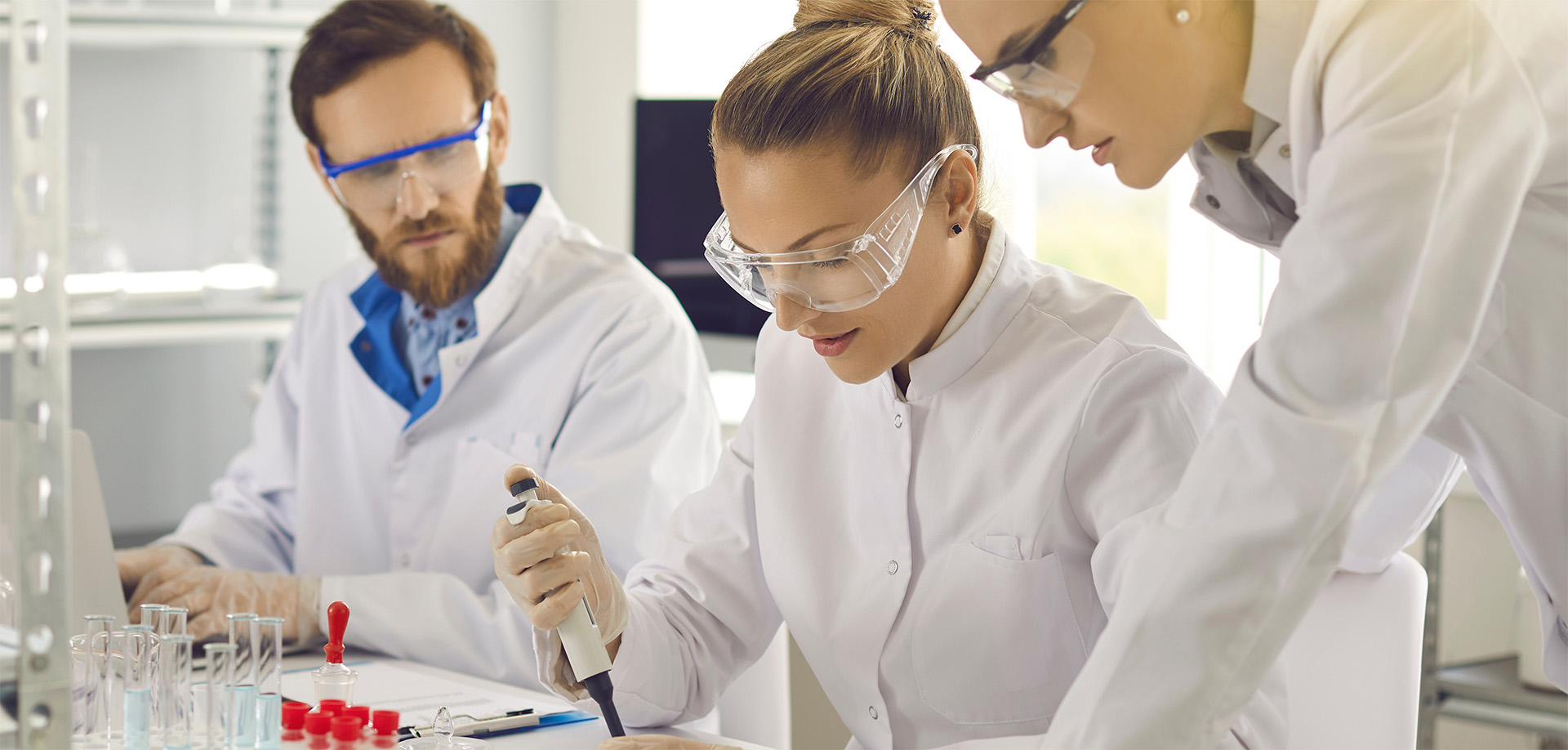 Group of scientists working in science laboratory. 