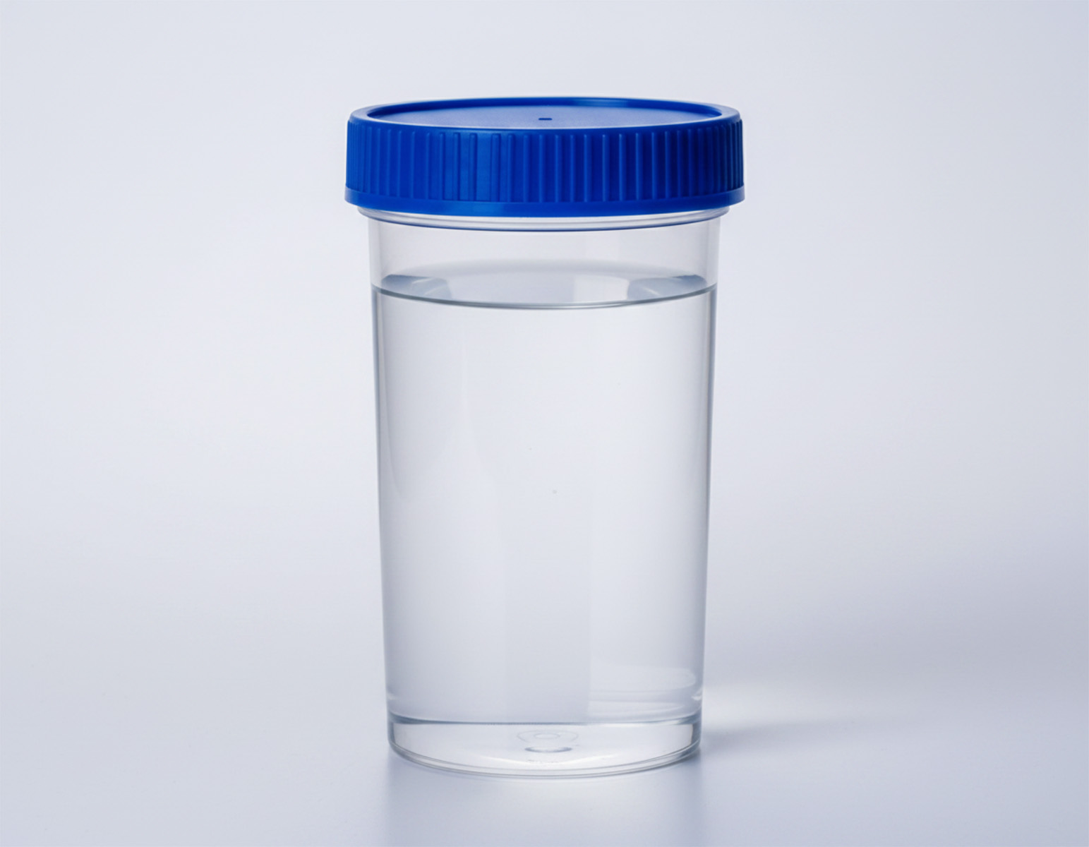 Transparent sample container with clear liquid and a blue screw cap on a neutral background.