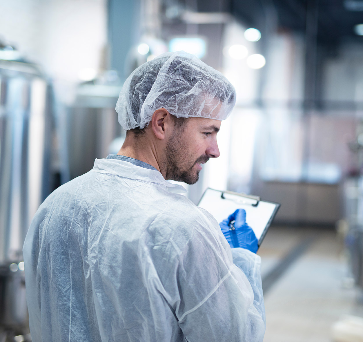 Scientist controlling production in factory. 