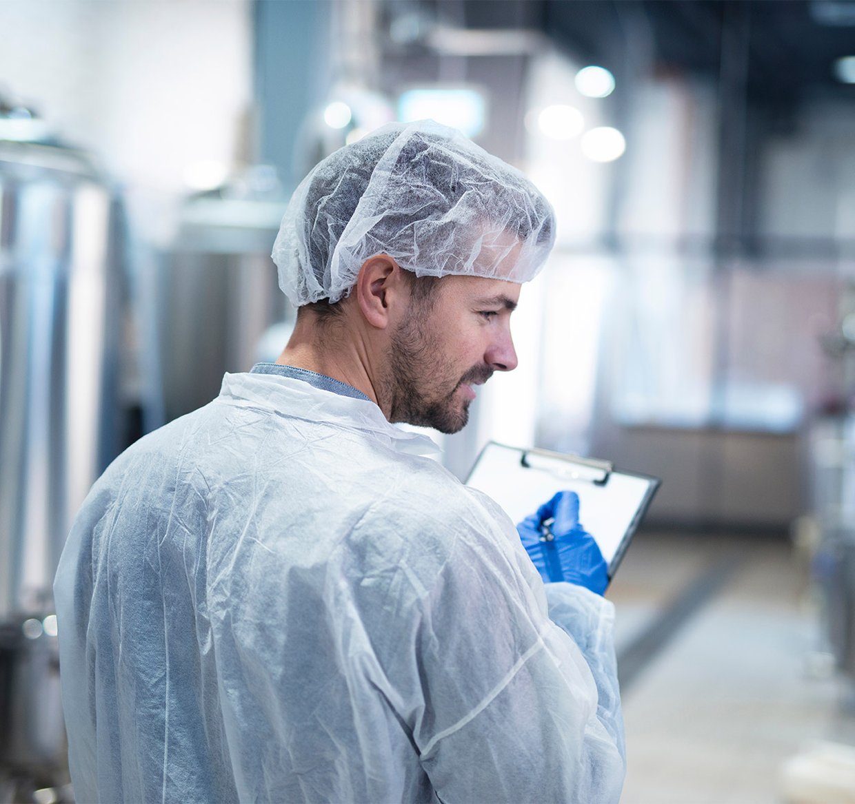 Scientist controlling production in factory.